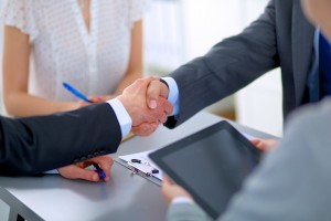 Business handshake. Business people shaking hands, finishing up a meeting