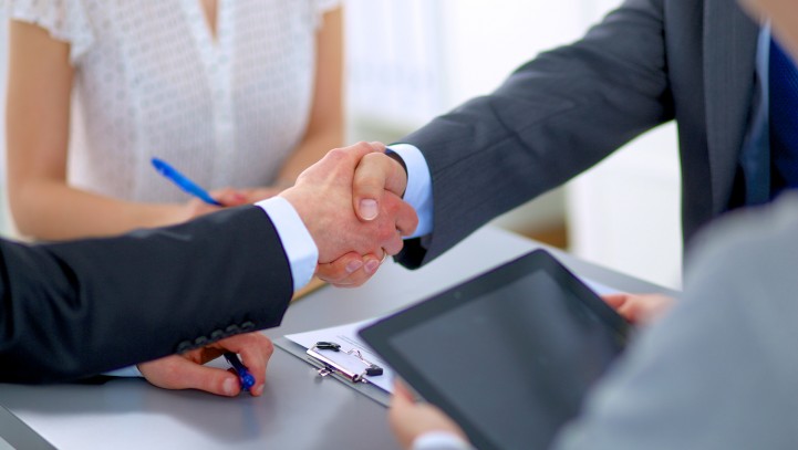 Business handshake. Business people shaking hands, finishing up a meeting